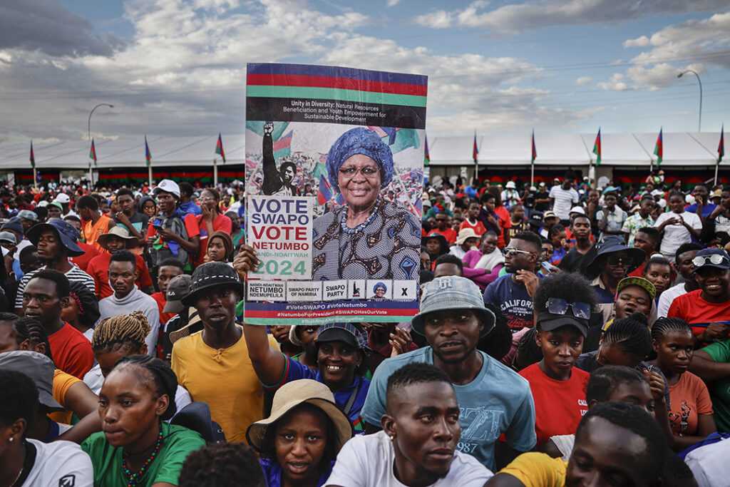 Supporters of SWAPO presidential candidate Netumbo Nandi-Ndaitwah hold her portrait at a campaign rally in Windhoek,