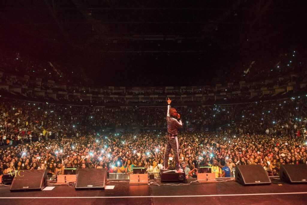 Nigerian music artist performing on stage at Detty December celebrations concert