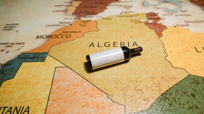 a,bottle,of,red,wine,on,a,map,of,algeria.